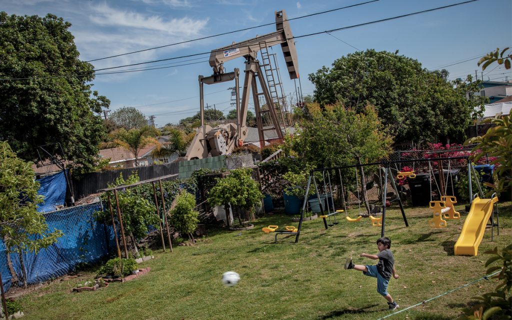 A PUMPJACK IN L.A.’S WILMINGTON NEIGHBORHOOD. ACROSS CALIFORNIA, MORE THAN 5 MILLION PEOPLE LIVE NEAR AN OIL OR GAS WELL, TWO-THIRDS OF WHOM ARE PEOPLE OF COLOR. PHOTO BY NACHO CORBELLA
