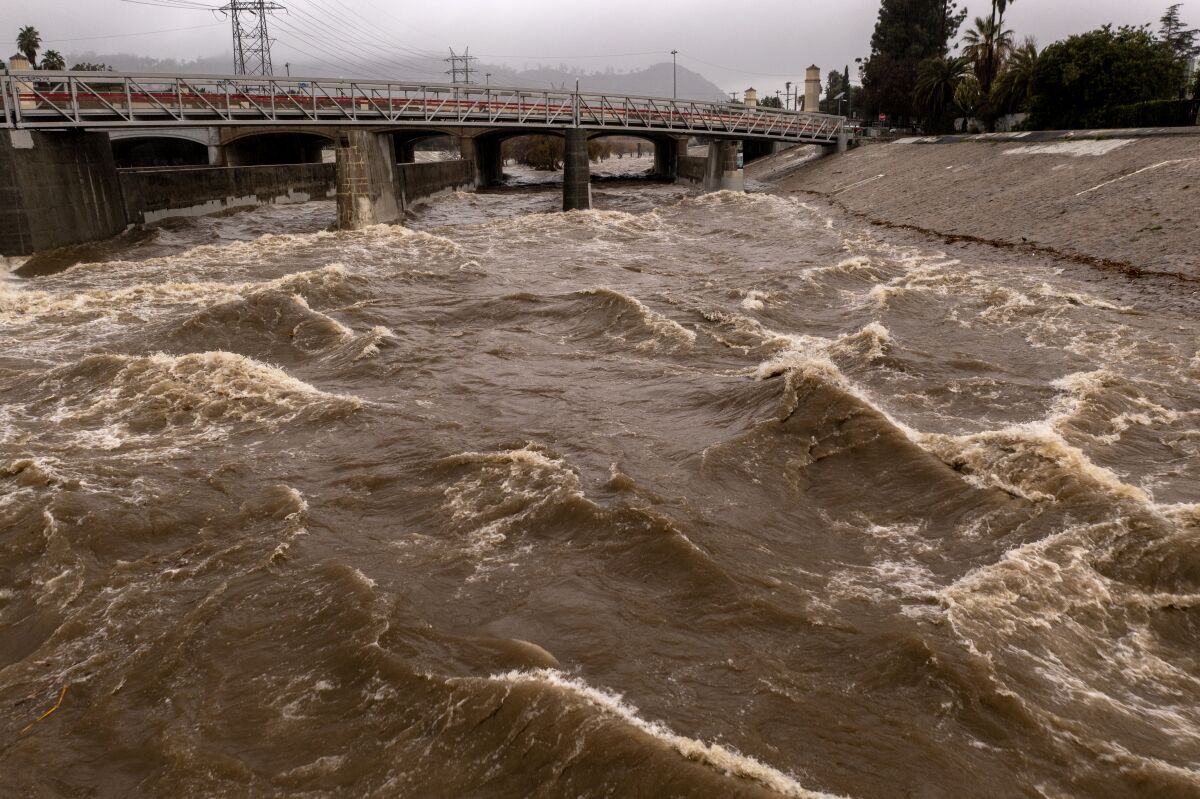 The Los Angeles River, which often runs at a trickle, is a raging torrent as powerful storms hit California on Jan. 5. (David McNew / Getty Images)