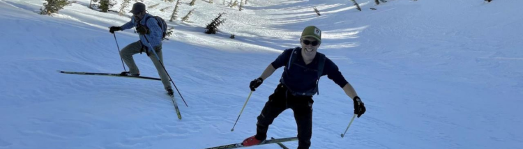 Morgan Goodwin and John Stanec climb the gully with Mammoth Mountain in the background