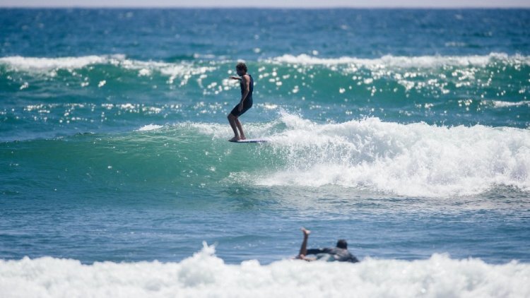 A classic perch for a classic wave. Tommy Witt, on point at Old Man's.