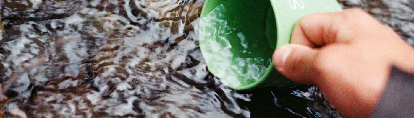 Dipping green cup in water