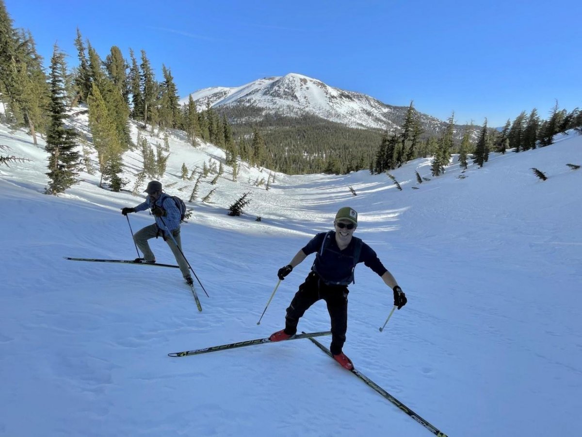 Morgan Goodwin and John Stanec climb the gully with Mammoth Mountain in the background
