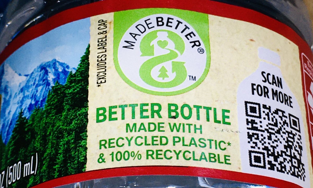 Zoomed in: Plastic water bottles with 100% recycled plastic* and 100% recyclable branding 