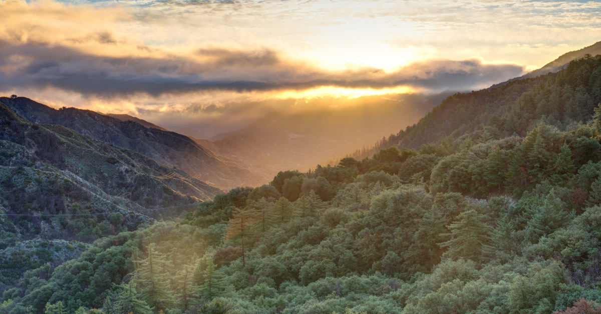 Sun rays peaking through clouds over Angeles National Forest