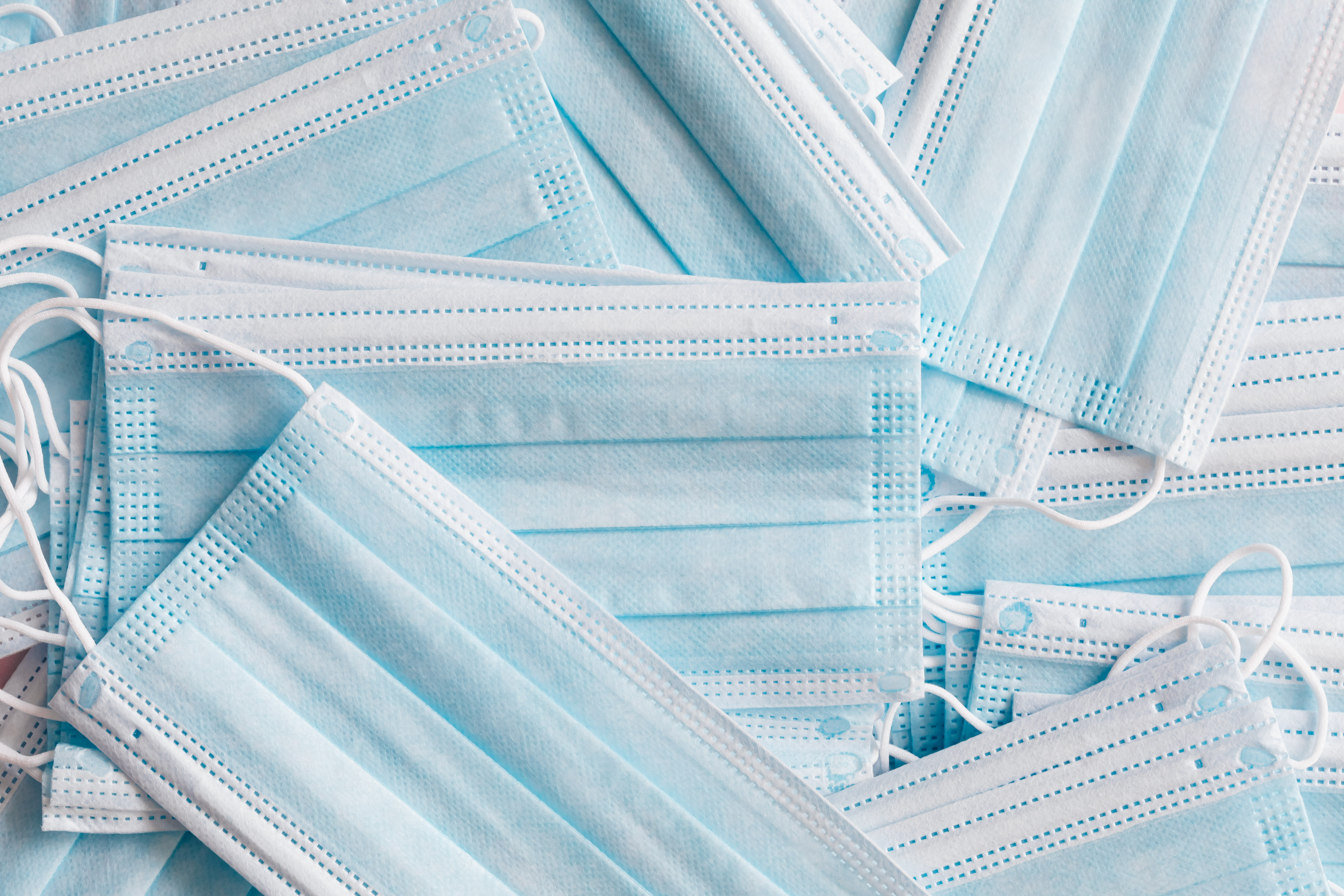 Blue single use medical face masks in a pile