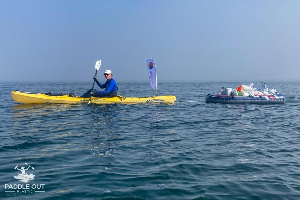 Paddle Out volunteer tows pile of plastic waste fished out of LA Harbor